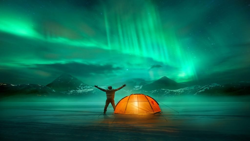 man camping northern lights