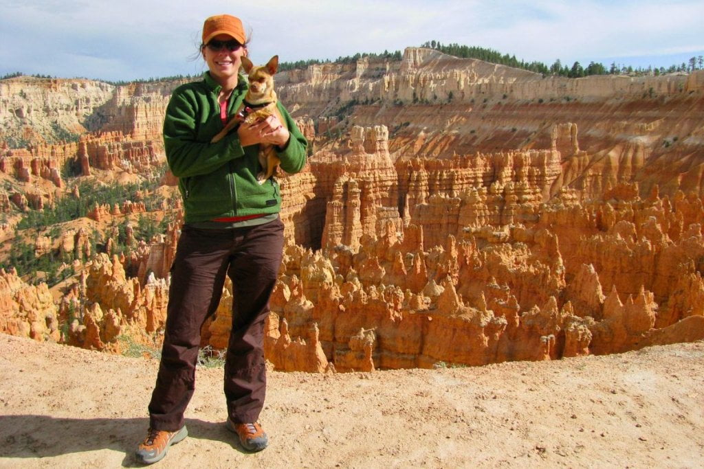 Ashlee and her dog with Bryce Canyon hoodoos in the background