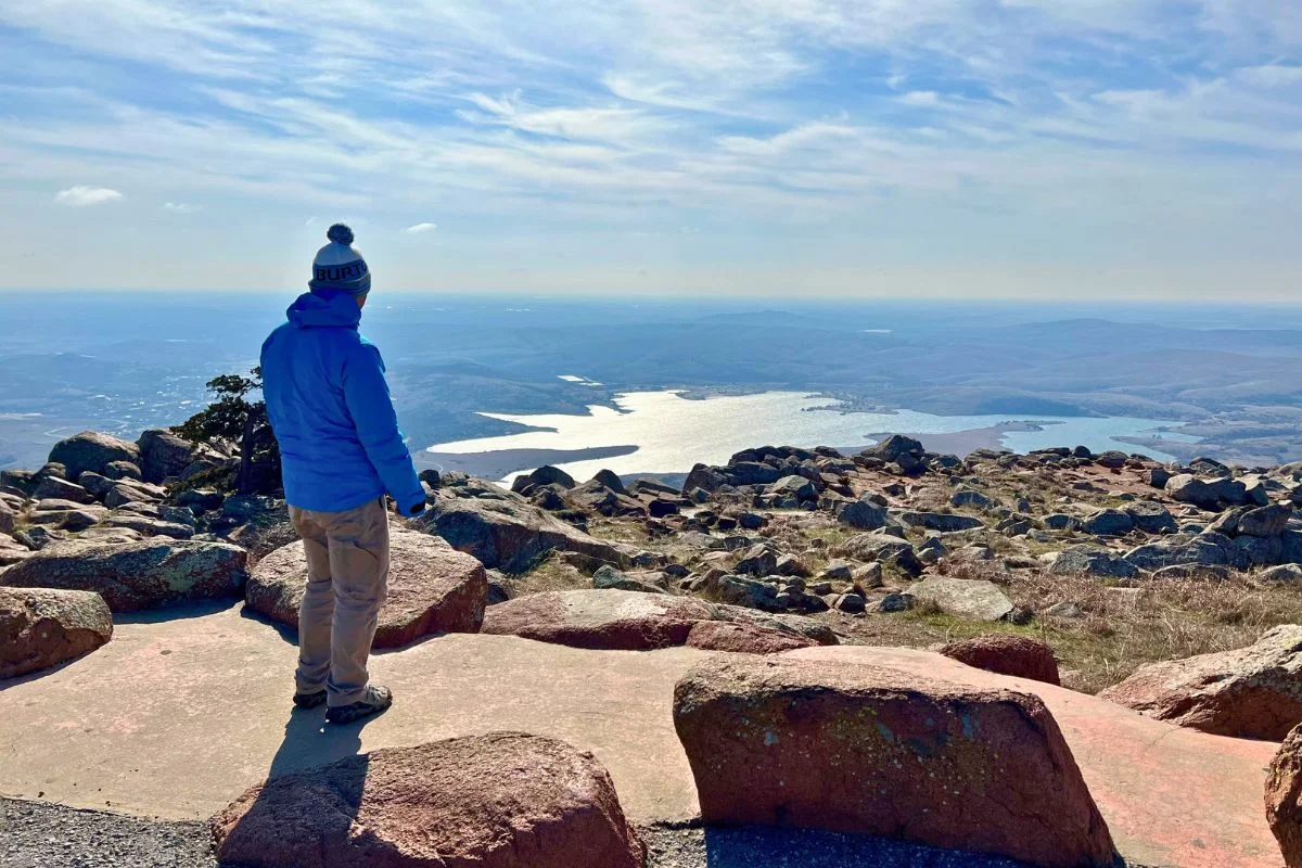 Man standing on the top of Mount Scott.