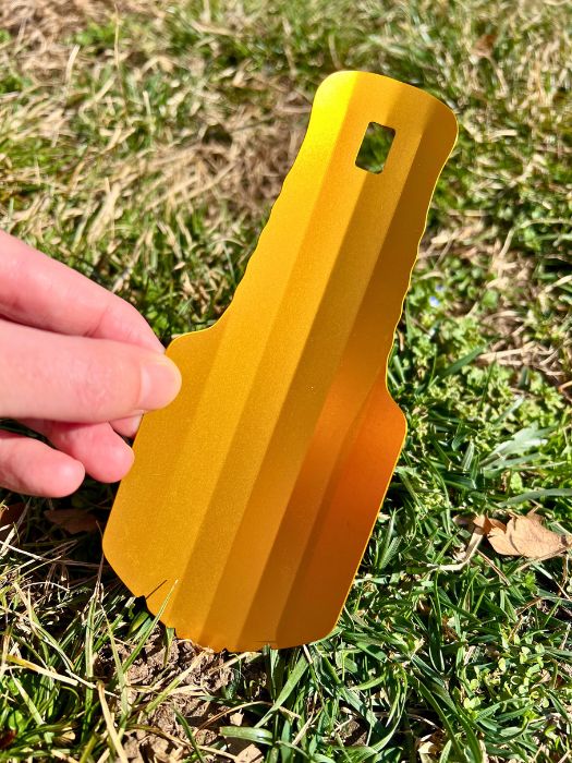 Orange "The Deuce" outdoor bathroom shovel.