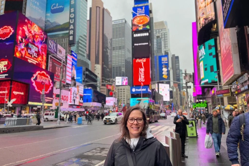 Ashlee standing in Times Square, NYC.