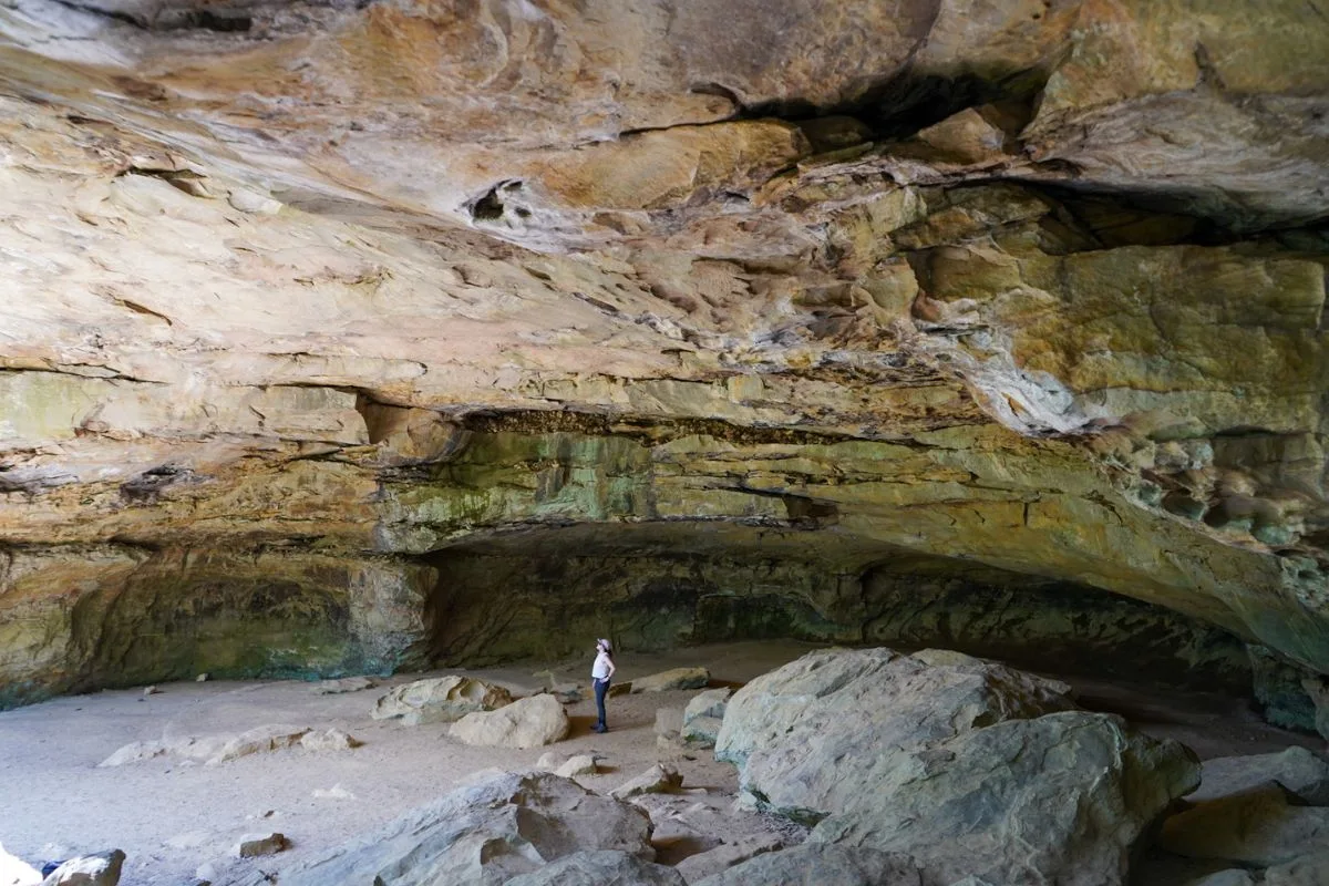 Ashlee standing in the Rock House Cave in Petit Jean State Park.