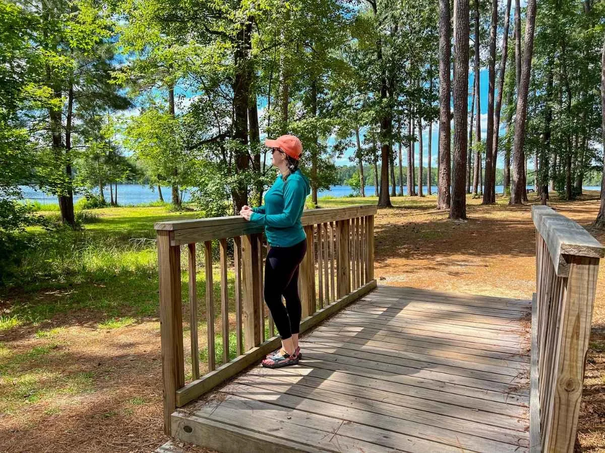 Ashlee hiking in Cheraw State Park looking at Lake Juniper