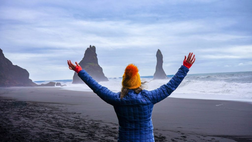 Standing in front of Iceland's famous sea stacks, visiting Iceland in September.