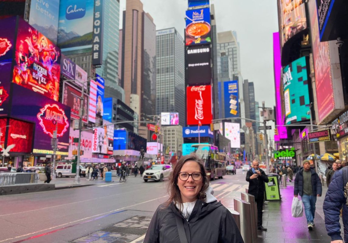 Ashlee standing in Times Square, NYC.