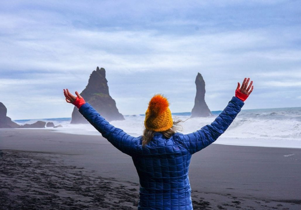 Standing in front of Iceland's famous sea stacks, visiting Iceland in September.
